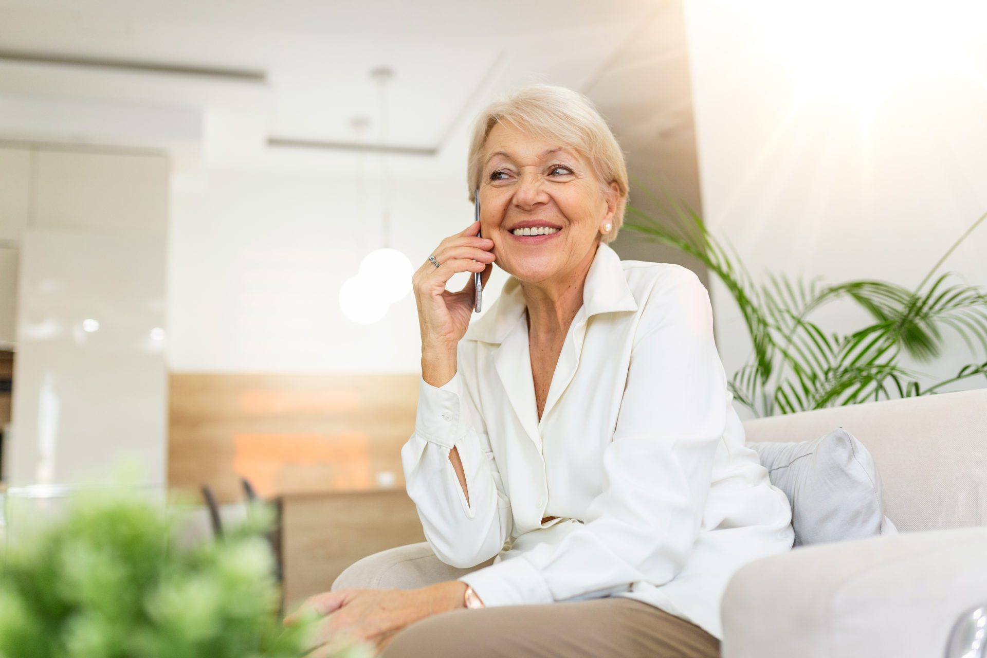 Elderly woman being told good news over the phone